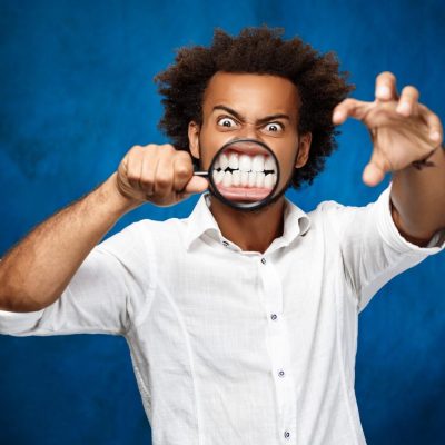 young-handsome-african-man-posing-with-magnifier-blue-wall1-Copy